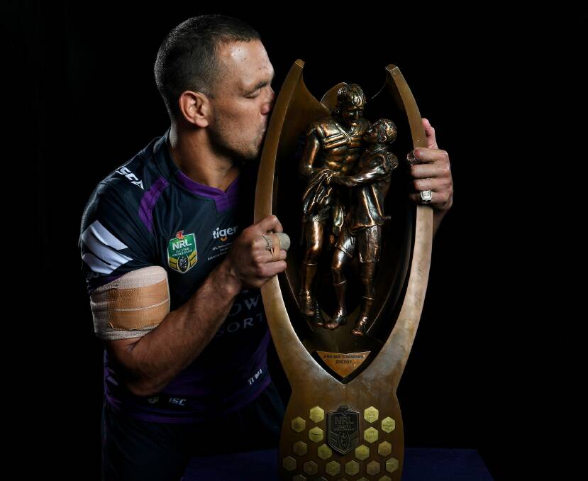 To the victor go the spoils: Will Chambers shares a moment with the NRL trophy after the grand final. Photo: NRL Imagery