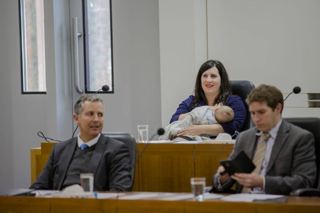 Giulia Jones, with Liberal colleagues Jeremy Hanson and Alistair Coe, makes history breastfeeding son Maximus in the ACT Chamber in August. Photo: Jamila Toderas