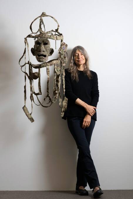  Fiona Hall in front of her work <i>All the Kings Men</i> from <i>Wrong Way Time</i>. Photo: David Mariuz