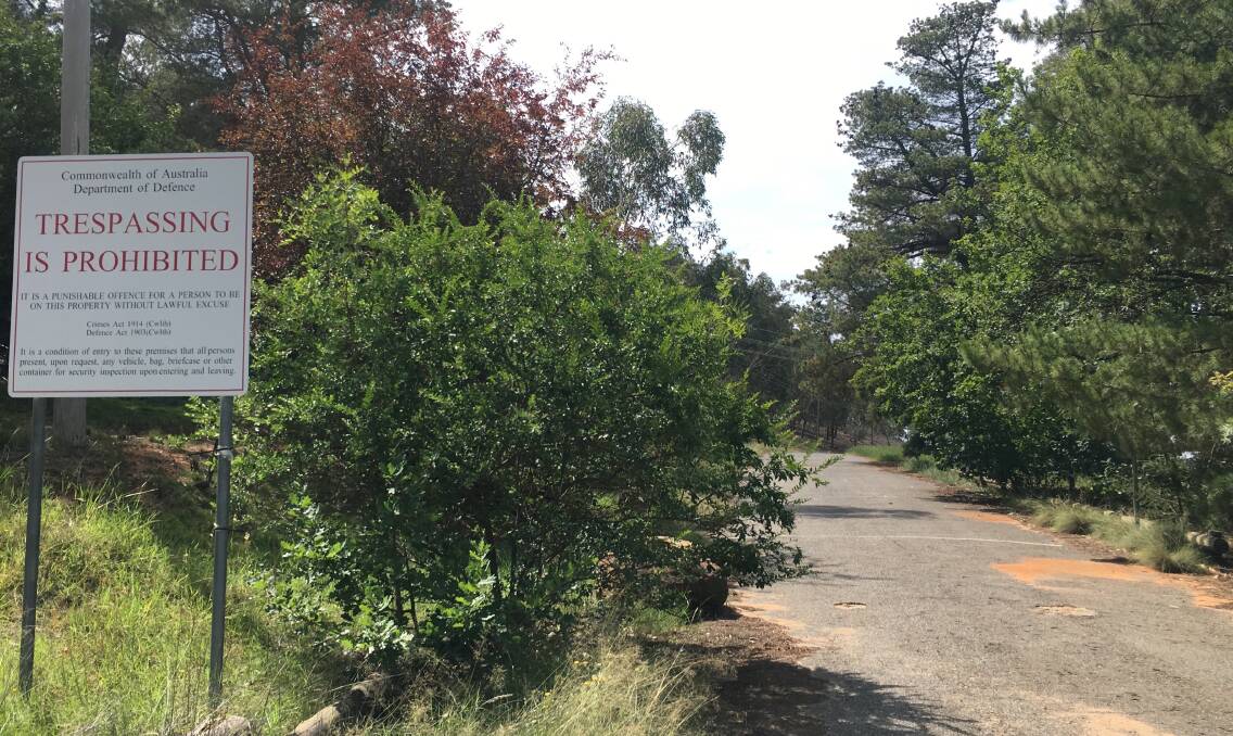 If you try to access Lavarack Road, Duntroon today, you will be met by 'Do Not Trespass' signs and an overgrown strip of asphalt. Photo: Supplied