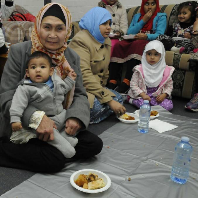 Celina Ciocon with 7-month-old grandson Abdurahman Durrani eating Iftar snacks. Photo: Georgina Connery