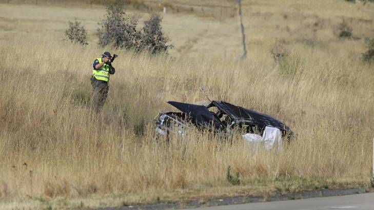 An investigator takes photos at the scene of the fatal accident near Holbrook. Photo courtesy of David Thorpe, Border Mail.