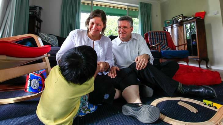Karin McDonald and husband Brendan Scott with their newly adopted Filipino son (name and face can not be revealed). Photo: Katherine Griffiths