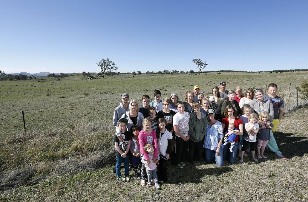 Uriarra village residents in front of the proposed site for a solar farm across the road to Uriarra Village. Photo: Jeffrey Chan