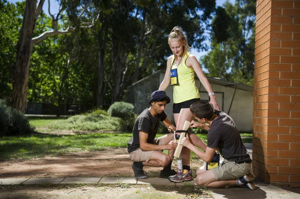 Keshav Kotecha, from Sydney, Abbey Godwin-Smith, from Hostrom, and Matt Dutton, from Adelaide, taking part in a prosthetic leg building exercise at the ANU College of Engineering.   Photo: Rohan Thomson