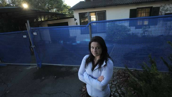 Downer resident Emily Scott lives across the road from this property in Bradfield Street which is due to be demolished because of the asbestos it contains. Photo: Graham Tidy