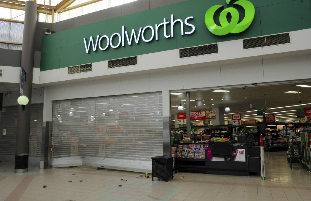 Packets of cigarettes were littered around the front of the Woolworths store at the Calwell Centre.  Photo: Graham Tidy
