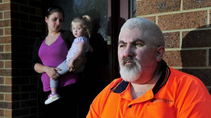 Michael Richer sits outside his house in Latham with his daughter Kylie Richer and granddaughter Sarah Watson after he lost his job from Douglas Quality Joinery. Photo: Jay Cronan
