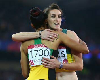 Canberra's Lauren Wells, fourth in the 400m hurdles at the Commonwealth Games, congratulates runner-up Kaliese Spence of Jamaica. Photo: Getty Images