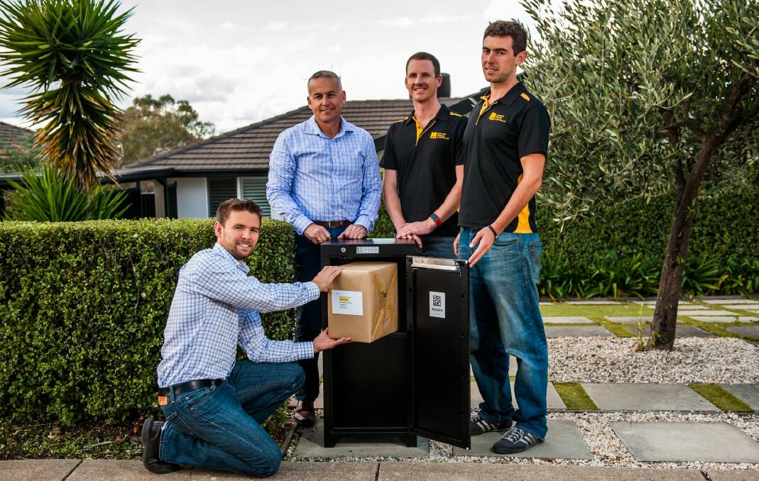 Smart Delivery Systems' Gordon Campbell, Norm Poulos, Andrew Elliott and Tom Shafron with one of the secure boxes. Photo: Elesa Kurtz