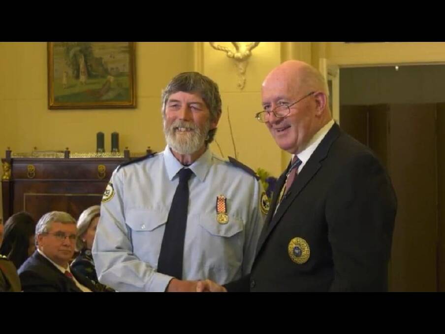 Graeme "Duck" Tonge, pictured left, receives a long service award to ACT SES from Govenor General Peter Cosgrove  Photo: Supplied