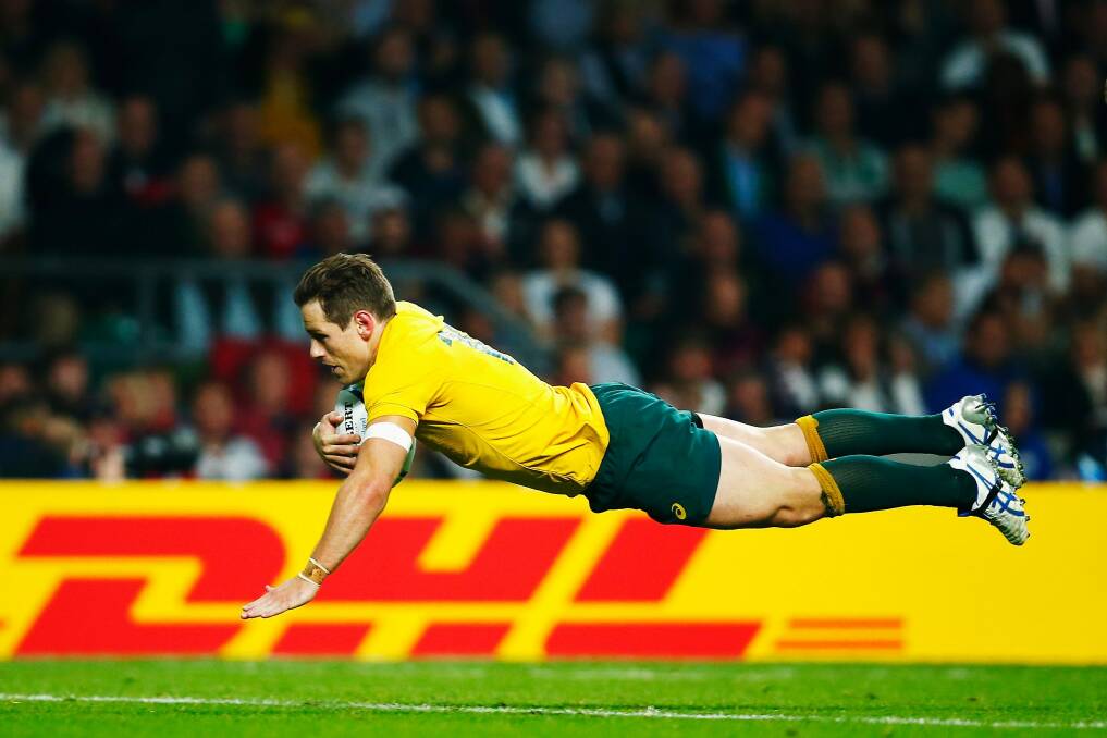 Striking a blow: Bernard Foley goes over to score Australia's second try. Photo: Getty Images