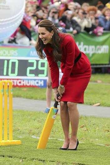The Duchess of Cambridge trying her hand at some cricket, in high heels. Photo: Martin Hunter