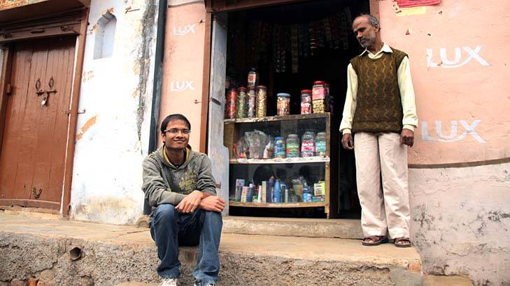 Self-driven: Student Uttam Kumar with his father, storekeeper Trilok Chand Mittal. Photo: Ben Doherty