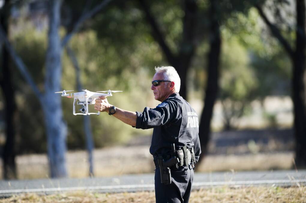 An AFP officer with a police drone. Photo: Rohan Thomson
