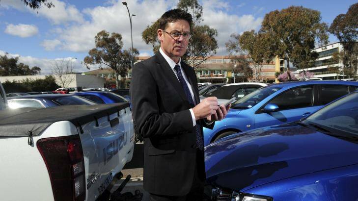 Director of Transport Regulations with ACT Justice and Community Safety, David Snowden, with one of the new hand-held devices used by parking inspectors to record infringements. Photo: Graham Tidy
