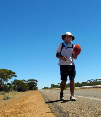 Matt Napier from a Wanniassa is walking from Perth to Sydney while bouncing an Aussie rules football to raise awareness for global poverty.