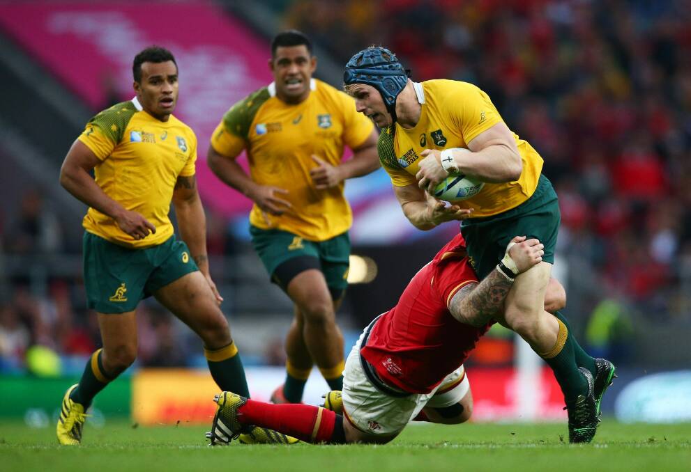 Brought down: David Pocock of Australia is tackled. Photo: Getty Images