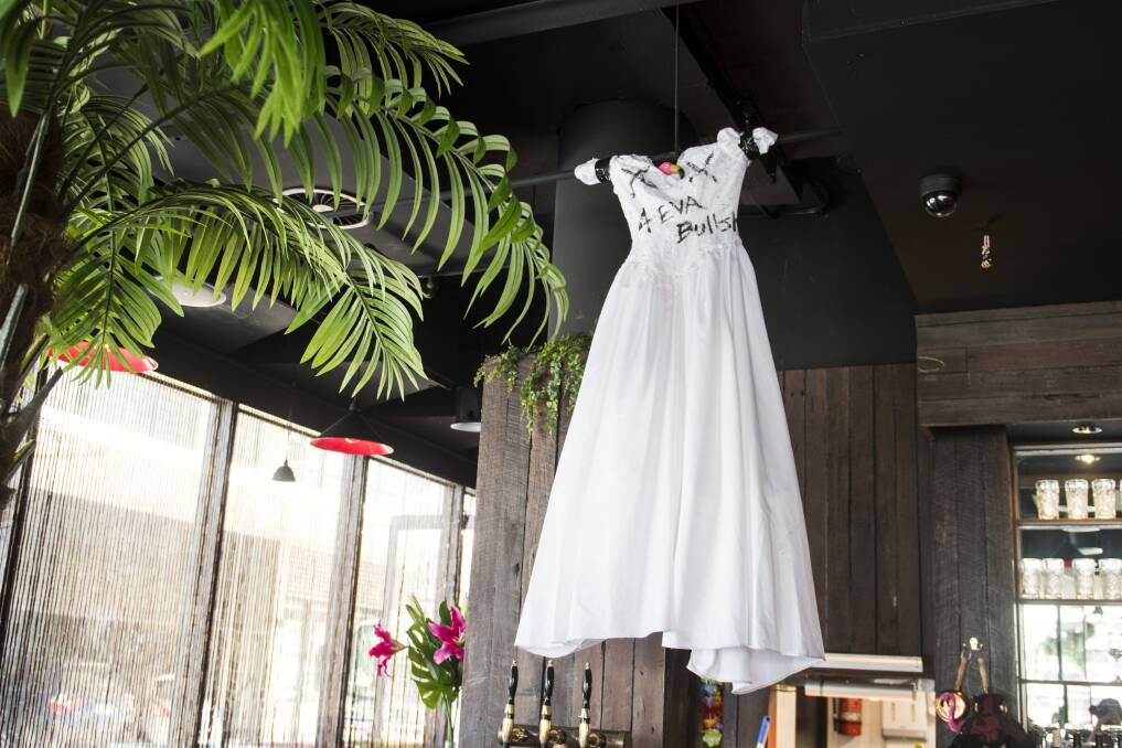 Betti's trashed wedding dress now hangs over the bar at the Kingston Foreshore restaurant. Photo: Dion Georgopoulos