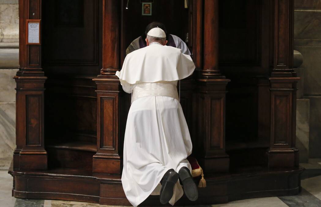 Pope Francis kneels in confession during a penitential liturgy in St. Peter's Basilica at the Vatican. Photo: AP
