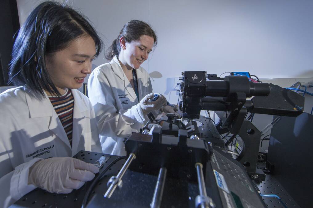 PhD scholar Sherry He and Dr Samantha Montague, from the Australian National University, work with their diagnostic device that reveals the formation of blood clots in patients. Photo: Supplied