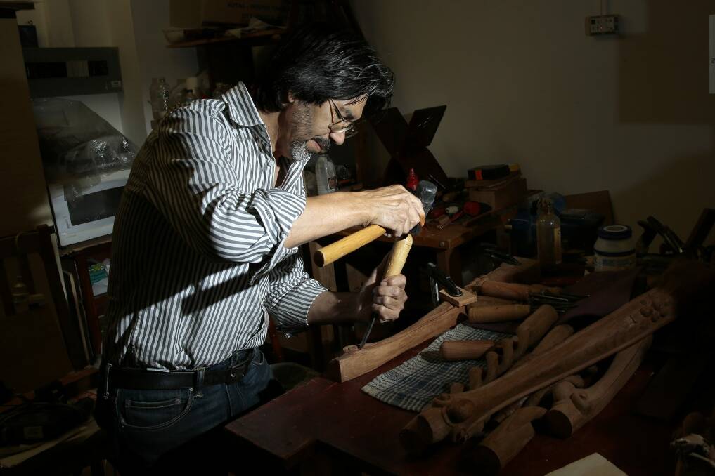 Afghan refugee and craftsman Hashmat Shafaq working on a table leg in his store Rosewood Furniture in Woden.  He was a woodworker in Afghanistan before he came to Australia in 1999. Photo: Jeffrey Chan