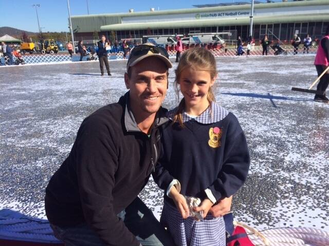 Matt Doble with his daughter Eve, seven. They travelled from Sydney to add the $973.35 in five cent pieces raised by the Oyster Bay Public School for the Big Heart Project. Photo: Megan Doherty