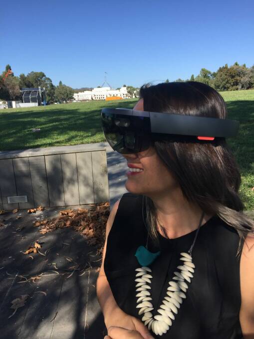 Mikaela Jade  with the Microsoft HoloLens which helps the user to interact with the stories, including rock art figures thousands of years old. Photo: Megan Doherty