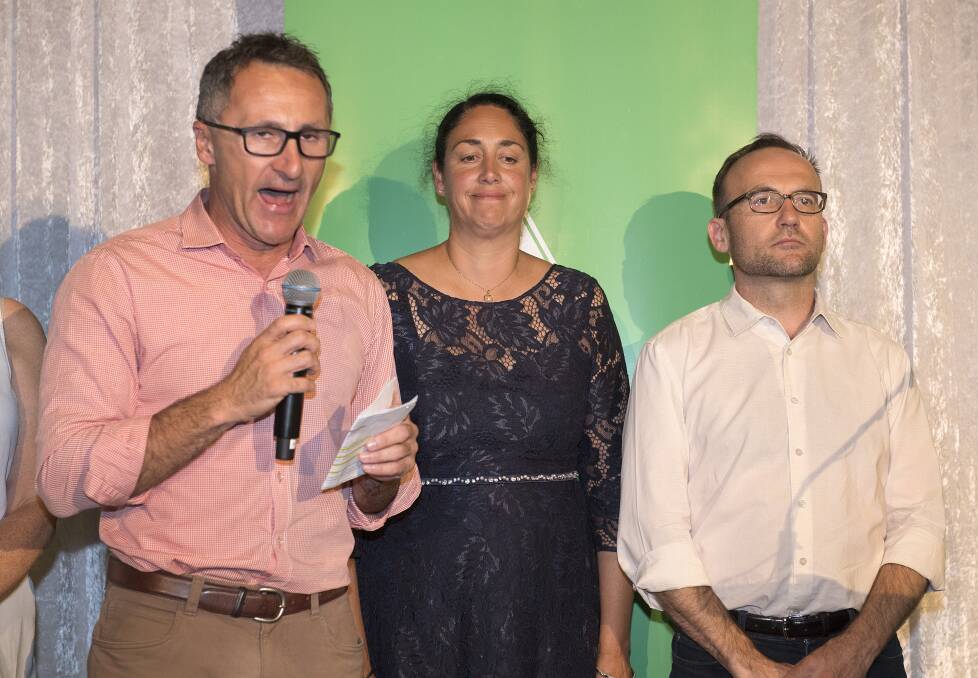 Standing with candidate Alex Bhathal and deputy leader Adam Bandt, Greens leader Richard Di Natale concedes defeat in Batman on Saturday,  Photo: AAP