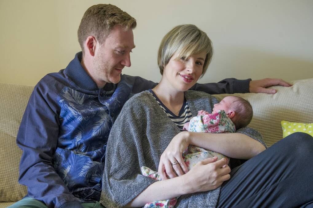 <i>The Voice's</i> Amber Nichols with husband Pete at home in Canberra with their new baby daughter Olive. Photo: Jay Cronan
