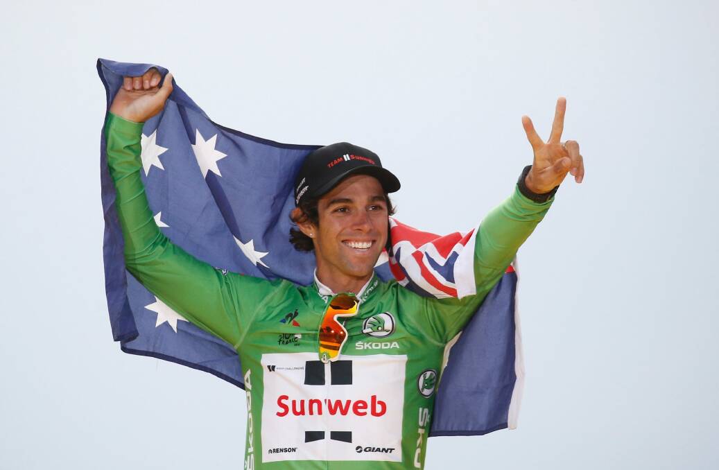 Australia's Michael Matthews celebrates after claiming the green jersey. Photo: AP