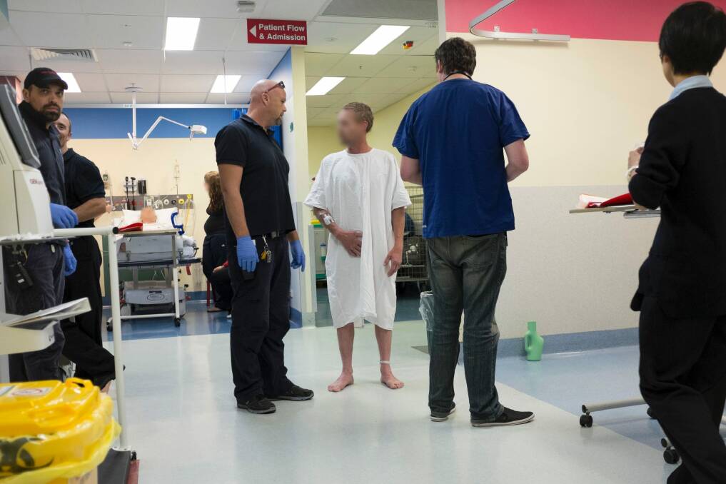 Security staff at Calvary Hospital talk to an intoxicated man. A national survey of 2000 emergency department staff found 92 per cent had been physically threatened by drunk patients, 98 per cent had been verbally abused and 88 per cent said the care of others had been negatively affected. Photo: Jay Cronan