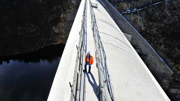Rachel Clarke stands on top of the Cotter Dam as workers make some final touches before the open day on Sunday. Photo: Jay Cronan
