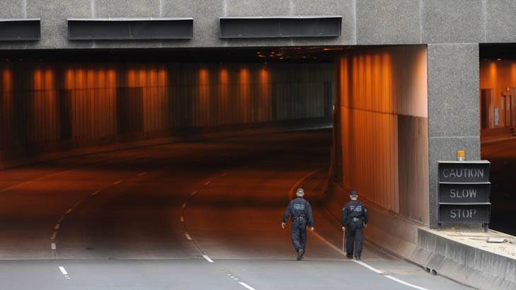 The Parkes Way tunnel in Acton, lit up in its trademark orange, during a police operation last year. Photo: Lannon Harley 
