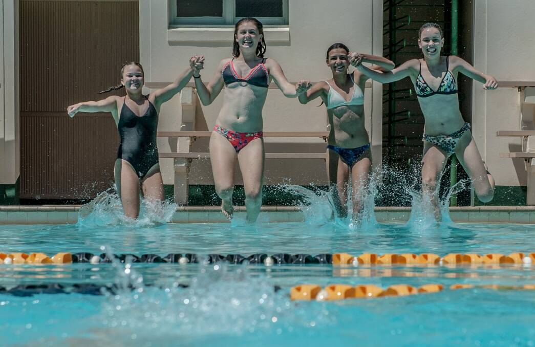 Georgia Austin, Claire Egan, Elizabeth de Souza and Alexandra Shield cool off at the Manuka Pool on Friday. Photo: Karleen Minney