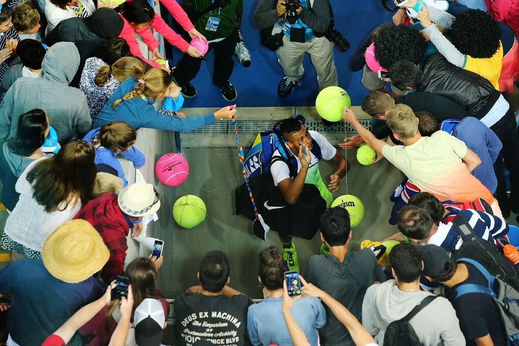Nick Kyrgios is mobbed after his win at the Australian Open. Photo: Getty Images