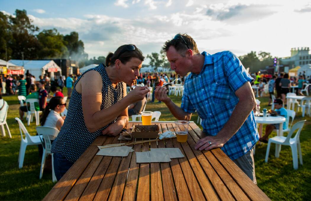 Erica Collins and Simon Bartle enjoy Japanese noodles at the first night of the Night Noodle Market. Photo: Elesa Kurtz