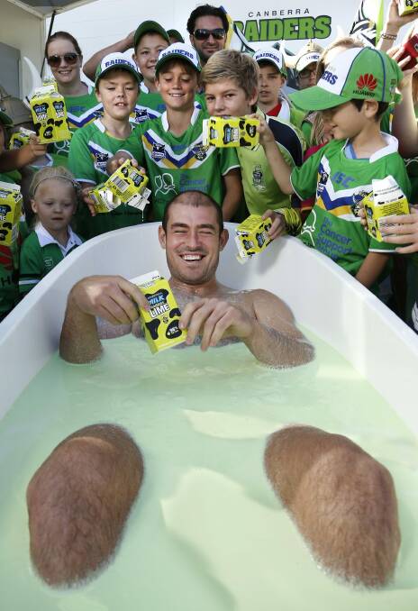 Canberra Raiders fans help give captain Terry Campese a bath of Raiders Lime during the members day at Canberra Stadium in March 2013. Photo: Jeffrey Chan