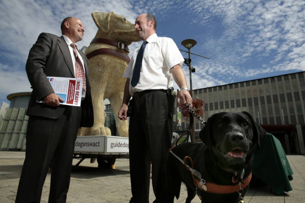 National Disability Services ACT manager Stephen Fox and guide dog handler John Barlow with Jazzy. Photo: Jeffrey Chan