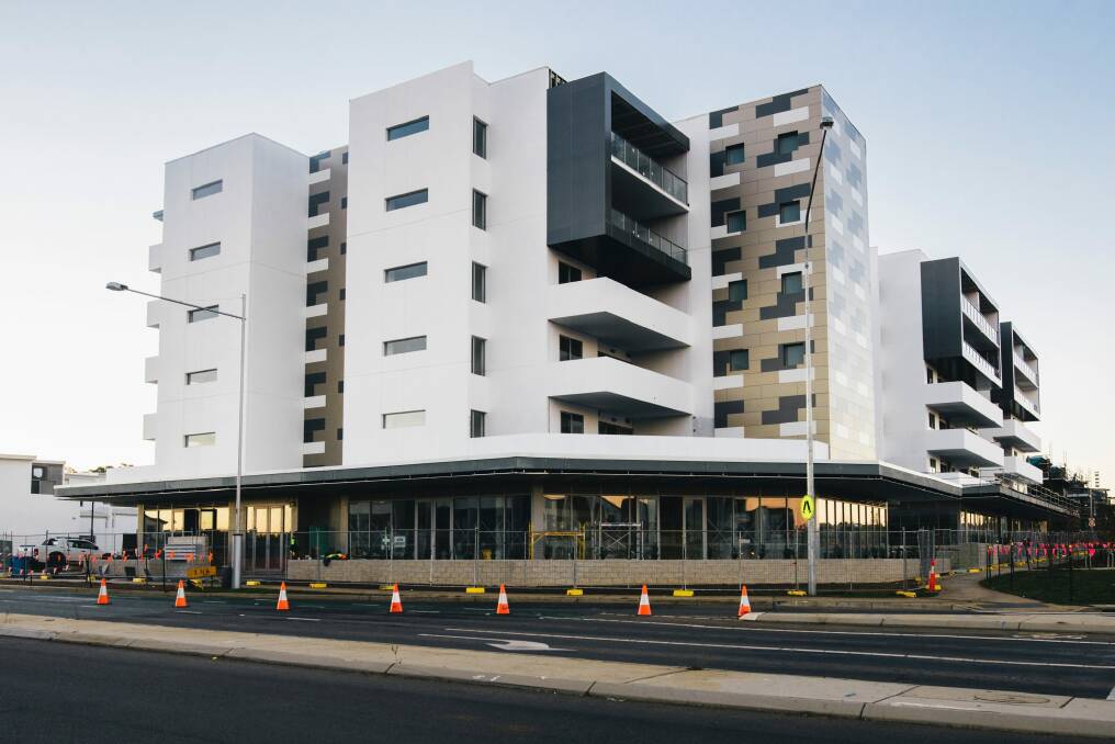 The Esque building on the corner of Flemington Road and Manning Clark Crescent in Franklin: The developers has offered to pay for electricity meters for apartment owners who can't get their chosen colour scheme. Photo: Rohan Thomson