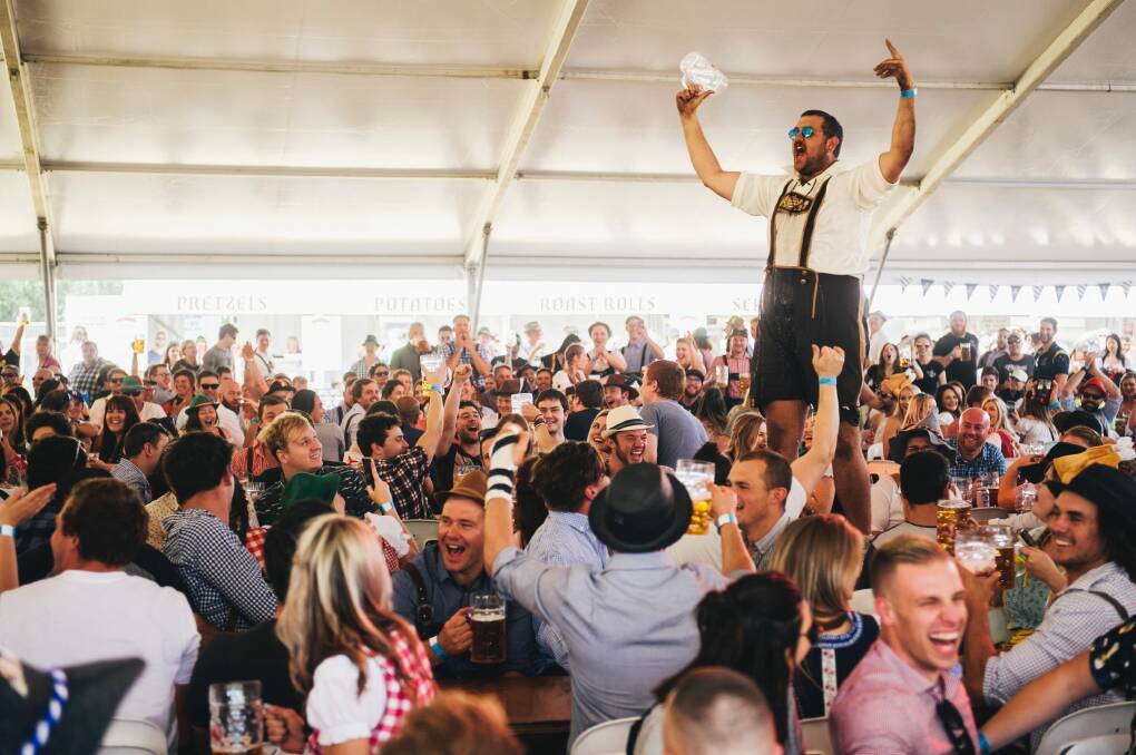 Dean Schmahl celebrates skolling a beer at Oktoberfest at the Queanbyean showground. Photo: Rohan Thomson
