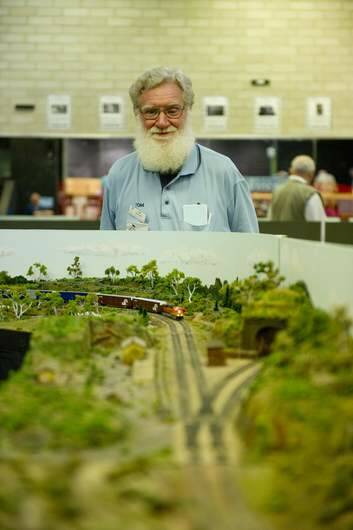 Tom Dowling of the Canberra Monaro N Scale Group setting up model train sets at UC High School Kaleen. Photo: Jay Cronan