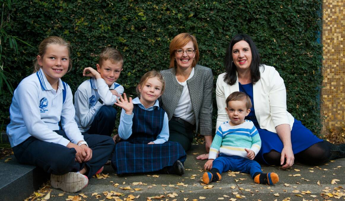 Labor's Meegan Fitzharris with her children, from left, Esther, 8, Al, 10, and Eva, 6, with Liberal Giulia Jones and her son Maximus, 1, in the Assembly courtyard.  Photo: Elesa Kurtz