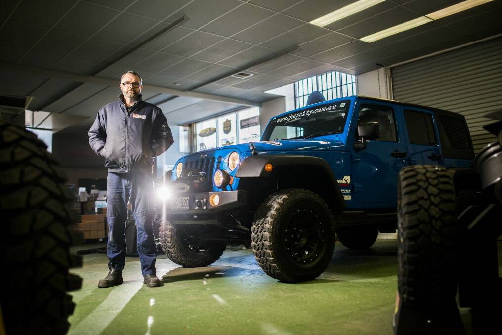 Jeep City owner Brett Quodling with a modified Jeep at his shop in Fyshwick. 
 Photo: Rohan Thomson