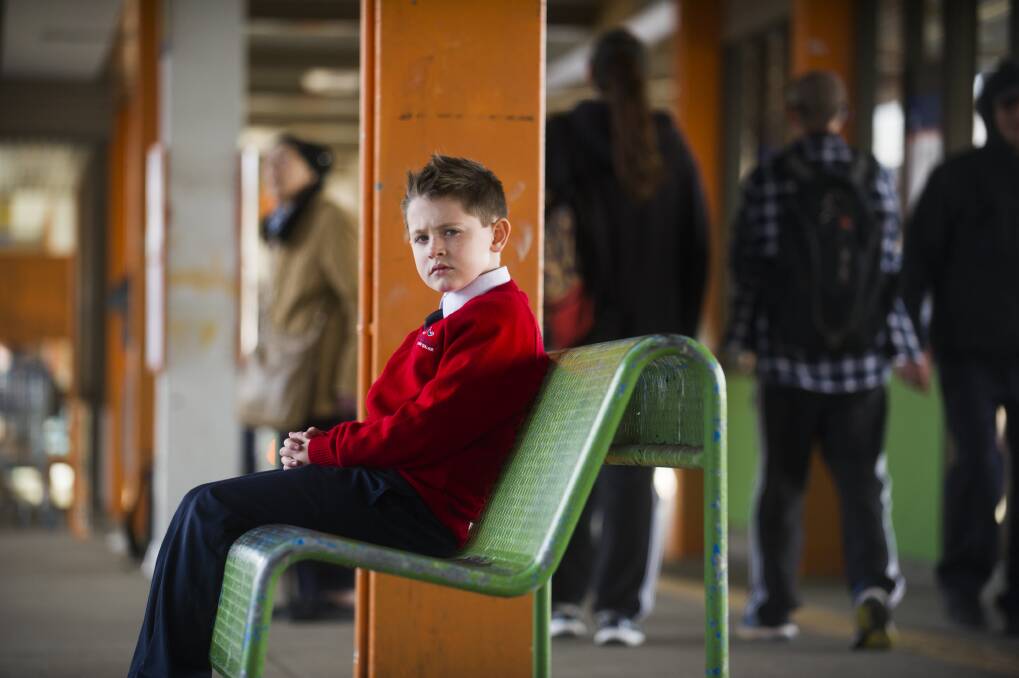 Elijah Sham, 7, will have to get on a public bus and make multiple connections to get to school from the Woden bus interchange Photo: Dion Georgopoulos