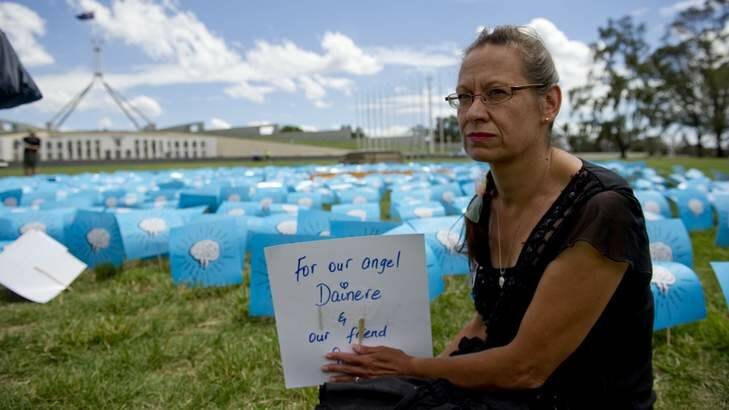Yvonne Anthoney holds up a sign for her her daughter Dainere who died of brain cancer. Photo: Jay Cronan
