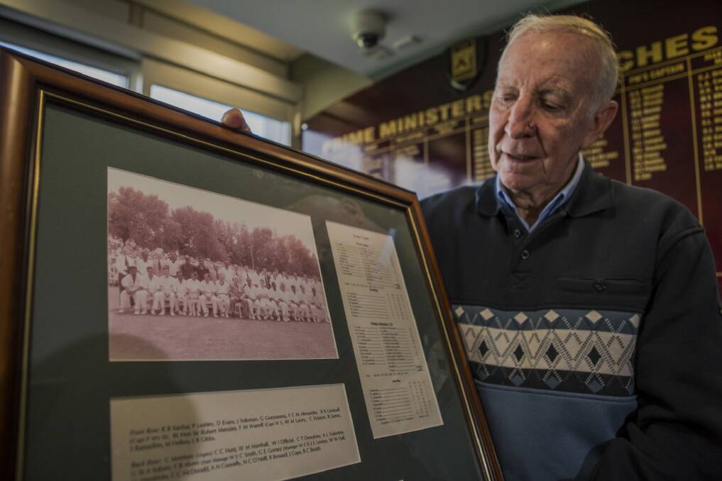 Canberra's John Cope, with the team photo of the 1961 Prime Minister's XI team and Richie Benaud. Photo: Jamila Toderas