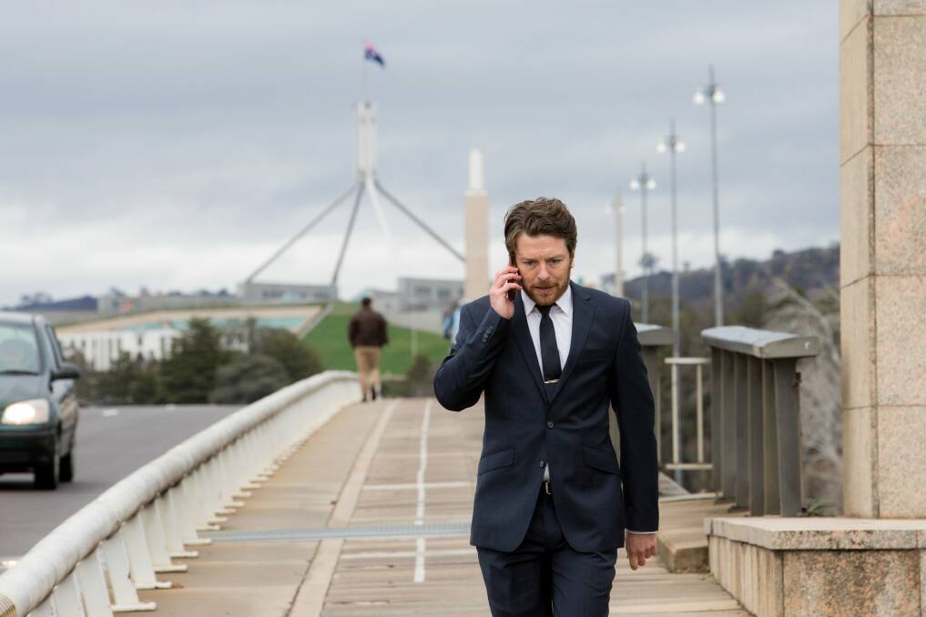 Star of the second series of The Code, Dan Spielman, as Ned Banks walks across Commonwealth Avenue Bridge in Canberra. Photo: Kate Ryan