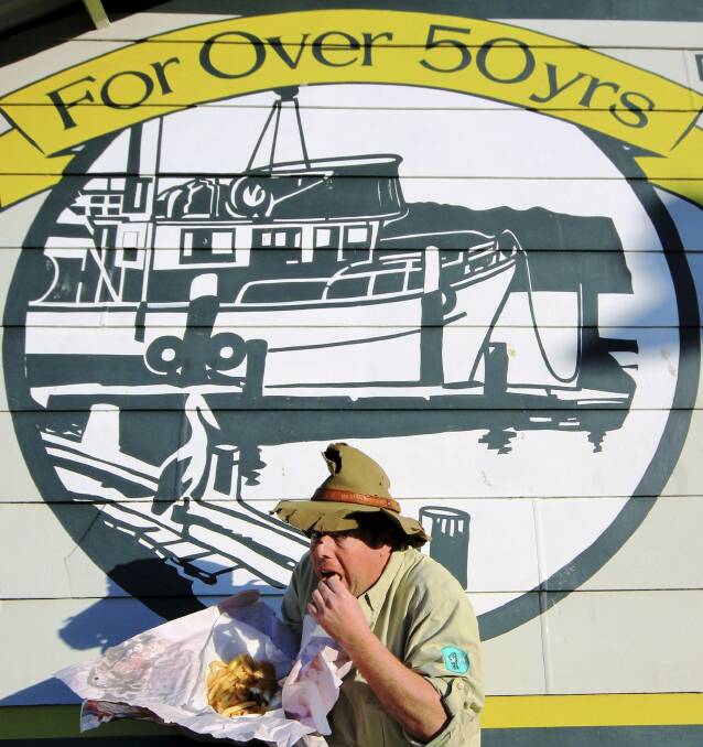 For research purposes: Tim the Yowie Man tucks into a feed of fish 'n' chips at the Innes Boatshed, Batemans Bay. Photo: Dave Moore