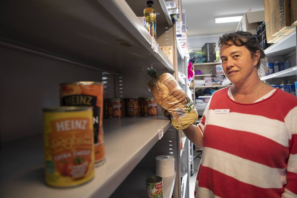 Volunteer Ruth Oldfield in the community pantry at St John's Care in Reid which is running out of food for the needy. Photo: Sitthixay Ditthavong